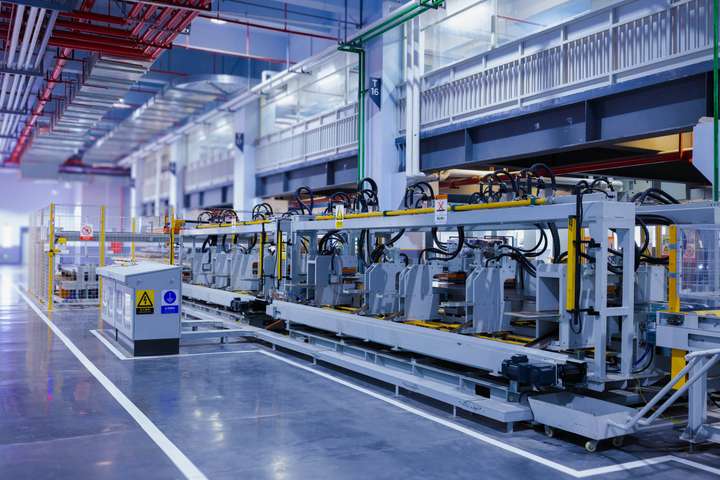 An automated panel-forming line in a bright production hall